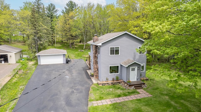 331 Locust St, Duluth, MN 55811 - view of front of property featuring an outdoor structure, a detached garage, a chimney, and a front lawn