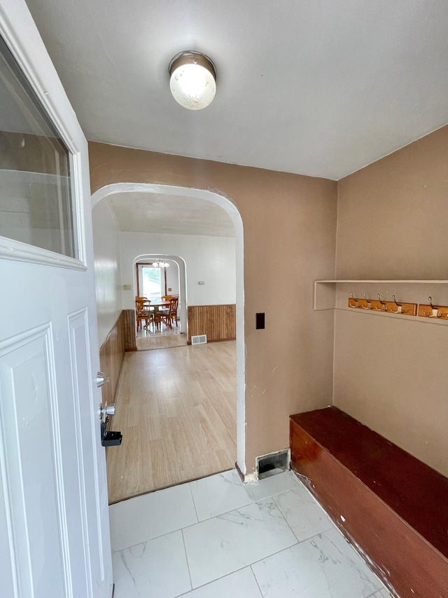 111 Park Ave, Springfield, MN 56087 - corridor with arched walkways, marble look tiles, and wainscoting