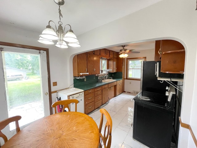 111 Park Ave, Springfield, MN 56087 - kitchen with arched walkways, black electric range, a chandelier, light marble finish flooring, and brown cabinets