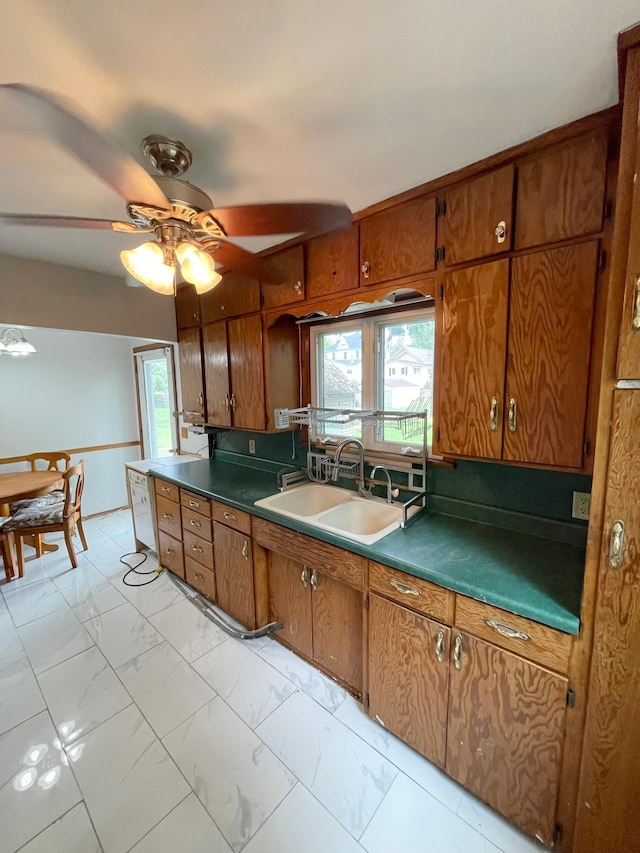 111 Park Ave, Springfield, MN 56087 - kitchen featuring light marble finish flooring, a sink, brown cabinetry, and ceiling fan