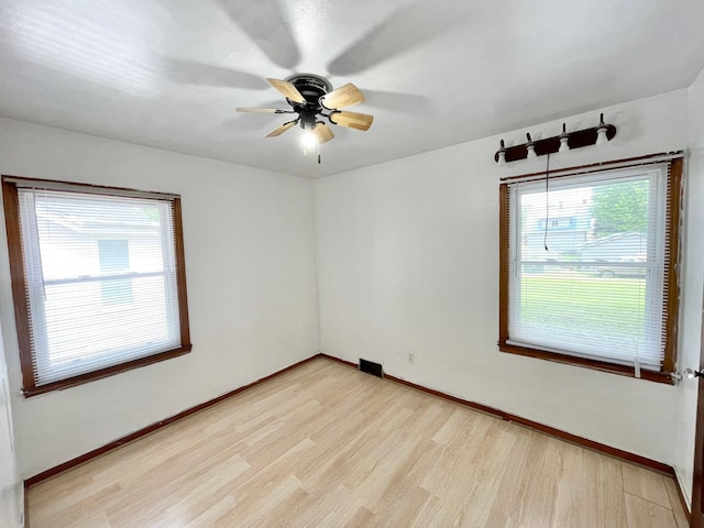 111 Park Ave, Springfield, MN 56087 - unfurnished room featuring light wood finished floors, a ceiling fan, and baseboards