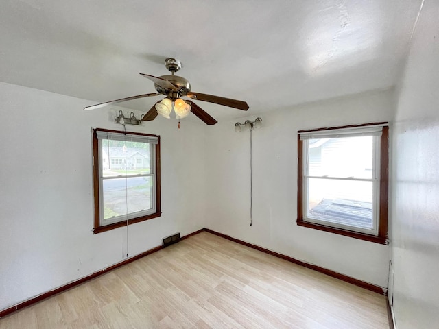 111 Park Ave, Springfield, MN 56087 - unfurnished room with light wood-style flooring, ceiling fan, and baseboards