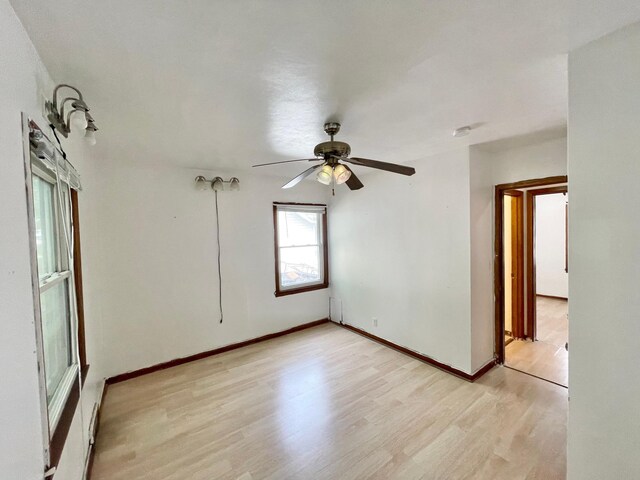 111 Park Ave, Springfield, MN 56087 - empty room featuring light wood-type flooring, ceiling fan, and baseboards