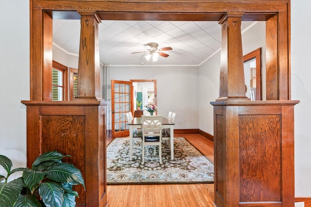 842 2nd St NW, Rochester, MN 55901 - dining room with ornamental molding, wood-type flooring, ceiling fan, decorative columns, and baseboards