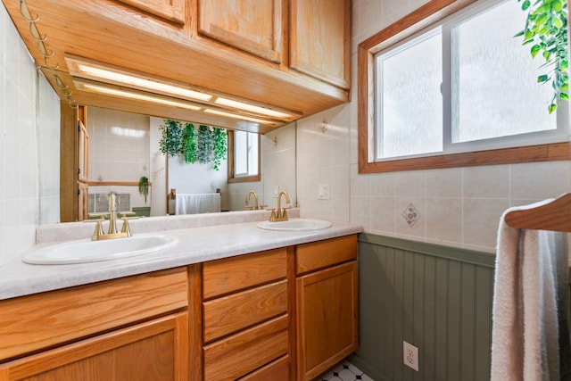 842 2nd St NW, Rochester, MN 55901 - full bathroom featuring double vanity, tile walls, and plenty of natural light