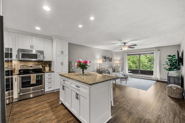 7510 Cahill Rd Unit 217B, Edina, MN 55439 - kitchen featuring appliances with stainless steel finishes, open floor plan, ceiling fan, dark wood-style flooring, and recessed lighting