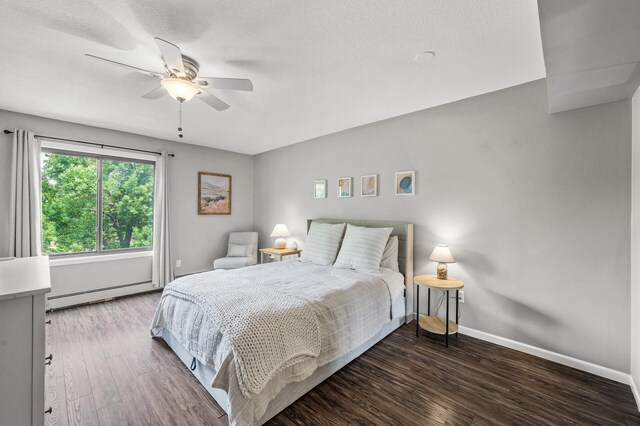 7510 Cahill Rd Unit 217B, Edina, MN 55439 - bedroom featuring a baseboard heating unit, wood finished floors, baseboards, and ceiling fan