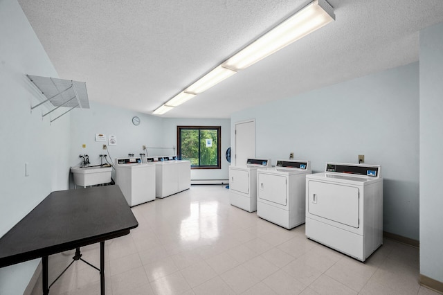 7510 Cahill Rd Unit 217B, Edina, MN 55439 - communal laundry room with washer and clothes dryer, a textured ceiling, and baseboards
