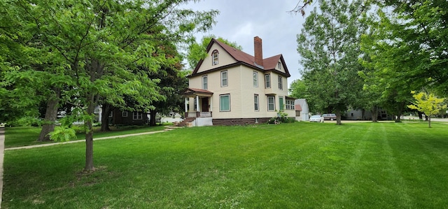 2753 Maple Ave, Slayton, MN 56172 - rear view of house featuring a chimney and a yard