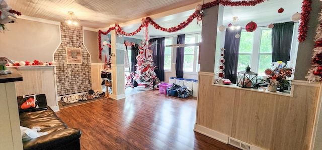2753 Maple Ave, Slayton, MN 56172 - living area with a wainscoted wall, ornamental molding, and wood finished floors