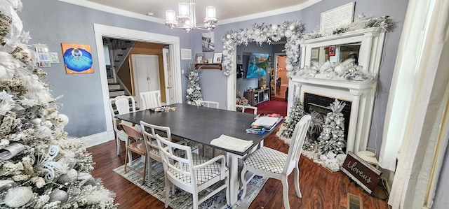 2753 Maple Ave, Slayton, MN 56172 - dining space with a chandelier, wood finished floors, stairway, ornamental molding, and a fireplace
