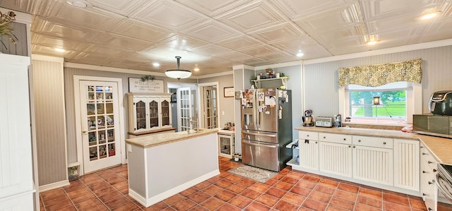 2753 Maple Ave, Slayton, MN 56172 - kitchen with stainless steel fridge with ice dispenser, light countertops, an ornate ceiling, light tile patterned floors, and pendant lighting