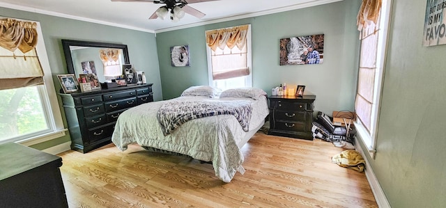 2753 Maple Ave, Slayton, MN 56172 - bedroom featuring multiple windows, ornamental molding, wood finished floors, baseboards, and a ceiling fan