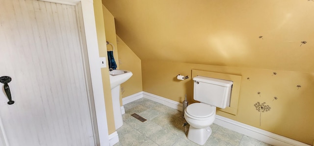 2753 Maple Ave, Slayton, MN 56172 - bathroom with toilet, lofted ceiling, and baseboards