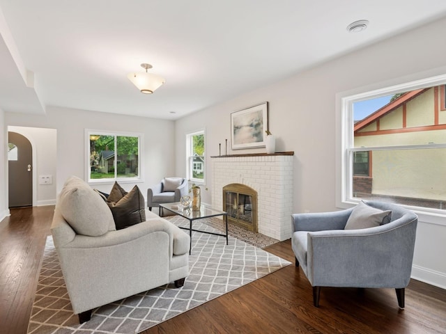 4816 3rd Ave S, Minneapolis, MN 55419 - living area with wood finished floors, arched walkways, a brick fireplace, and baseboards