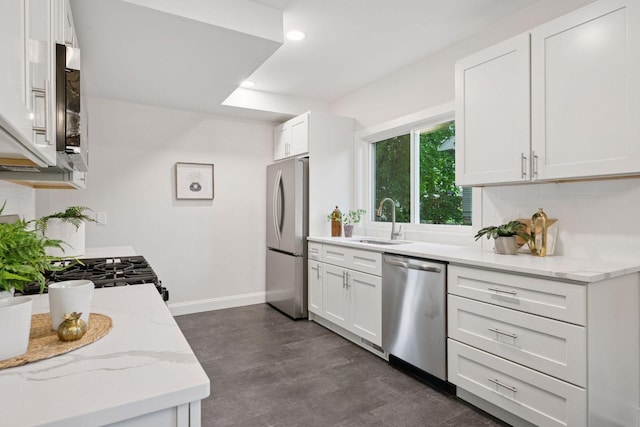4816 3rd Ave S, Minneapolis, MN 55419 - kitchen featuring appliances with stainless steel finishes, a sink, white cabinets, light stone counters, and recessed lighting