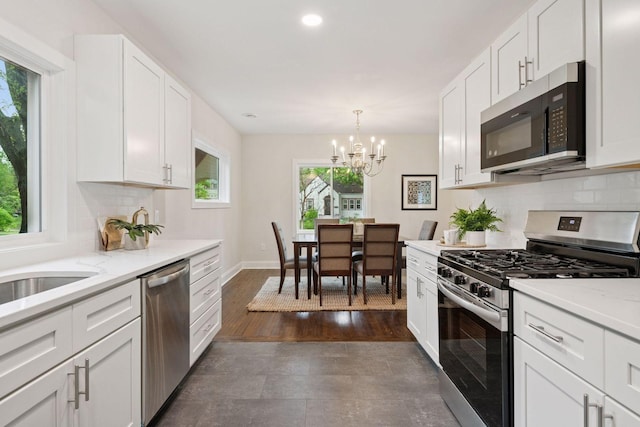 4816 3rd Ave S, Minneapolis, MN 55419 - kitchen featuring appliances with stainless steel finishes, plenty of natural light, a chandelier, decorative backsplash, and recessed lighting