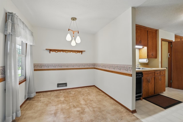 11748 Bittersweet St NW, Coon Rapids, MN 55433 - kitchen with light countertops, brown cabinets, baseboards, light colored carpet, and a sink