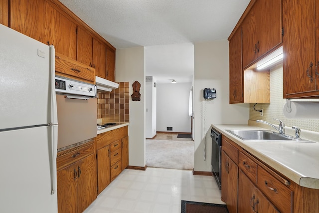 11748 Bittersweet St NW, Coon Rapids, MN 55433 - kitchen featuring freestanding refrigerator, a sink, decorative backsplash, light countertops, and black dishwasher