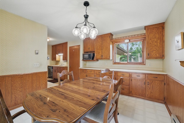 11748 Bittersweet St NW, Coon Rapids, MN 55433 - dining room with a baseboard heating unit, a wainscoted wall, light floors, wallpapered walls, and a chandelier