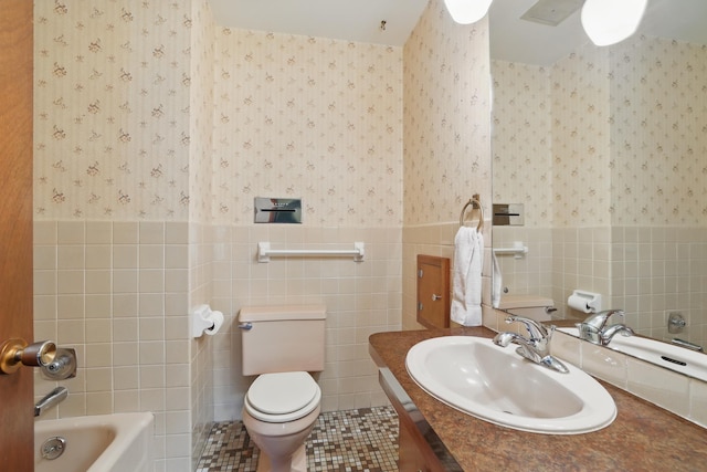 11748 Bittersweet St NW, Coon Rapids, MN 55433 - bathroom featuring wallpapered walls, tile walls, a tub to relax in, a wainscoted wall, and toilet