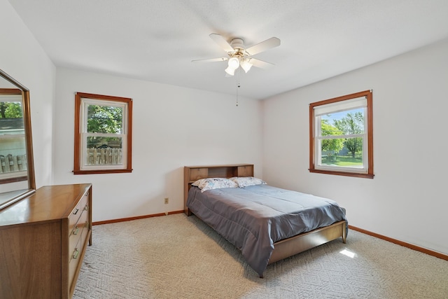 11748 Bittersweet St NW, Coon Rapids, MN 55433 - bedroom featuring multiple windows, light carpet, baseboards, and a ceiling fan