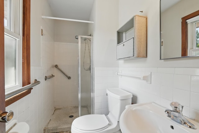 11748 Bittersweet St NW, Coon Rapids, MN 55433 - full bathroom with a sink, tile walls, toilet, a stall shower, and wainscoting