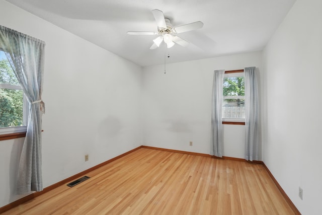 11748 Bittersweet St NW, Coon Rapids, MN 55433 - spare room featuring light wood finished floors, a ceiling fan, and baseboards
