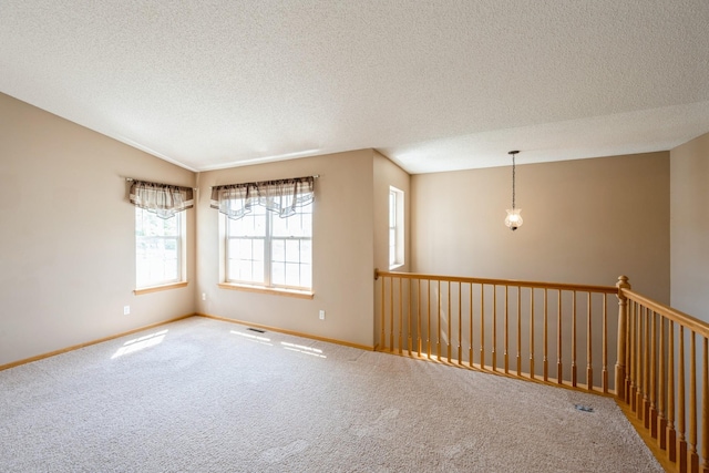 1005 Providence Dr, Shakopee, MN 55379 - carpeted empty room with a textured ceiling, baseboards, and lofted ceiling