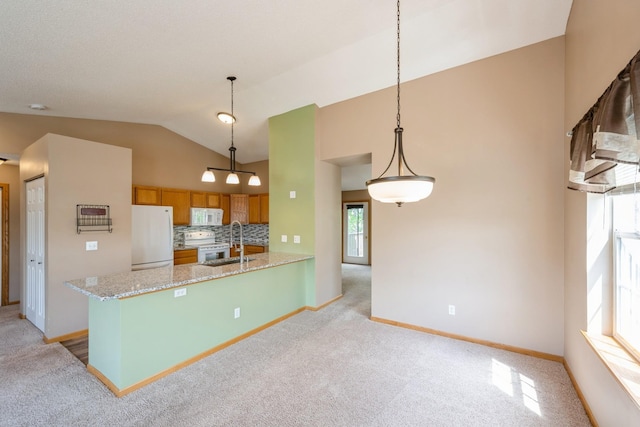 1005 Providence Dr, Shakopee, MN 55379 - kitchen with white appliances, brown cabinets, light carpet, vaulted ceiling, and a sink