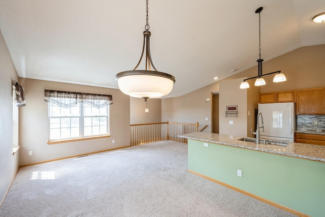 1005 Providence Dr, Shakopee, MN 55379 - kitchen with freestanding refrigerator, a sink, vaulted ceiling, light carpet, and hanging light fixtures