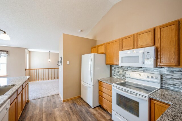 1005 Providence Dr, Shakopee, MN 55379 - kitchen featuring white appliances, dark wood-style floors, tasteful backsplash, lofted ceiling, and light stone counters