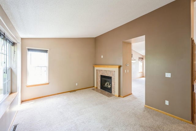 1005 Providence Dr, Shakopee, MN 55379 - unfurnished living room featuring carpet floors, a fireplace, baseboards, and a textured ceiling