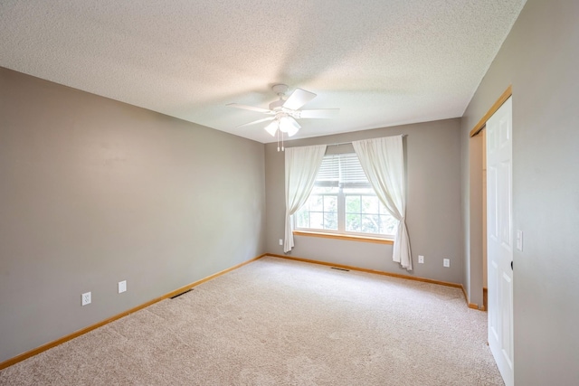 1005 Providence Dr, Shakopee, MN 55379 - unfurnished room featuring ceiling fan, light colored carpet, baseboards, and a textured ceiling