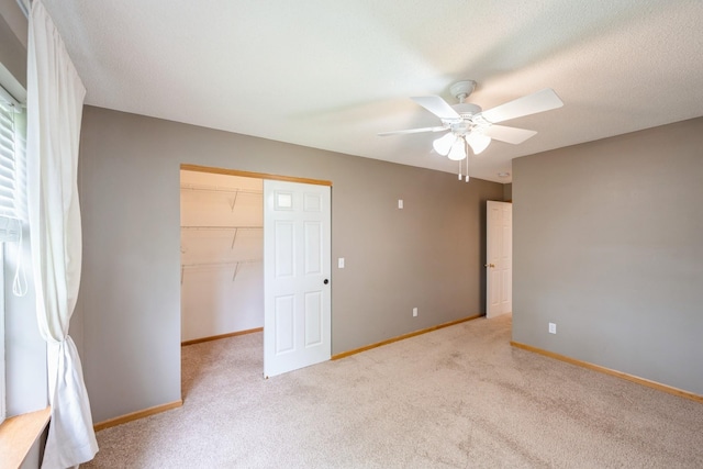 1005 Providence Dr, Shakopee, MN 55379 - unfurnished bedroom featuring light carpet, baseboards, a spacious closet, a closet, and ceiling fan