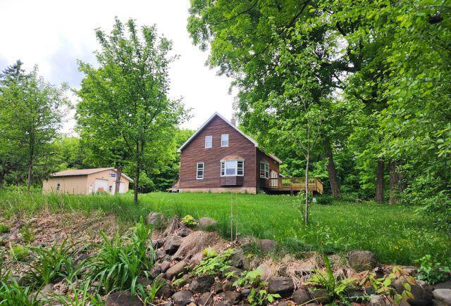 1561 240th Ave, Luck Twp, WI 54853 - view of side of home featuring an outbuilding and a deck
