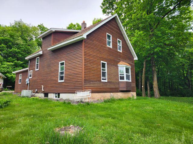 1561 240th Ave, Luck Twp, WI 54853 - view of side of property featuring a chimney and a lawn