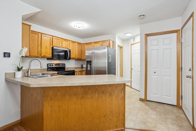16480 Elm Creek Ln, Lakeville, MN 55044 - kitchen with appliances with stainless steel finishes, a peninsula, light countertops, a textured ceiling, and brown cabinetry