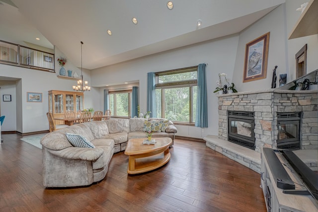 1167 56th St, Hudson, WI 54016 - living area with a stone fireplace, a chandelier, wood-type flooring, high vaulted ceiling, and recessed lighting