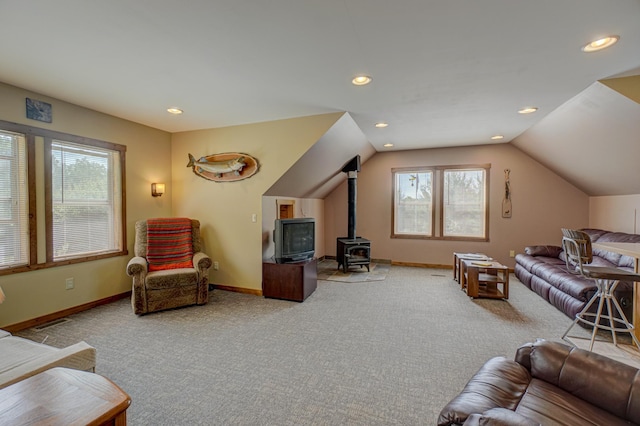 1167 56th St, Hudson, WI 54016 - living room with carpet floors, a wood stove, healthy amount of natural light, recessed lighting, and vaulted ceiling