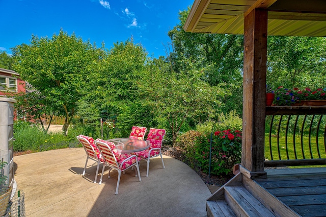 1167 56th St, Hudson, WI 54016 - view of patio featuring outdoor dining space and a wooden deck