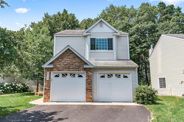 5711 Donegal Dr, Shoreview, MN 55126 - view of front facade with a shingled roof, asphalt driveway, a front yard, and a garage
