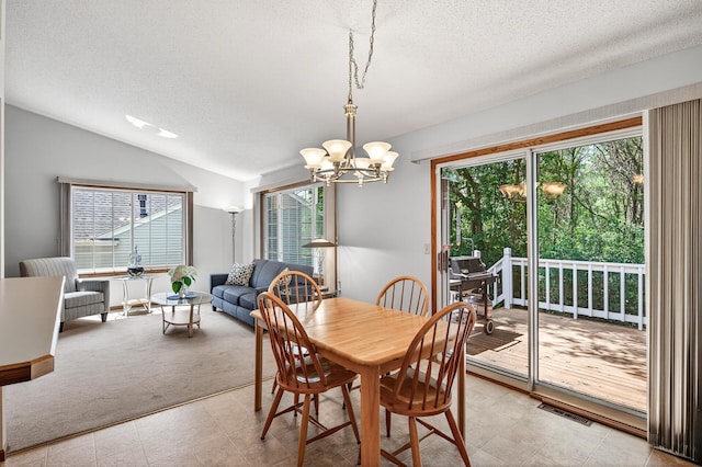 5711 Donegal Dr, Shoreview, MN 55126 - dining space with a textured ceiling, plenty of natural light, lofted ceiling, a chandelier, and light carpet