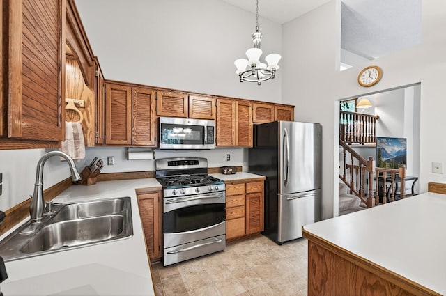 5711 Donegal Dr, Shoreview, MN 55126 - kitchen featuring stainless steel appliances, a chandelier, brown cabinetry, decorative light fixtures, and high vaulted ceiling
