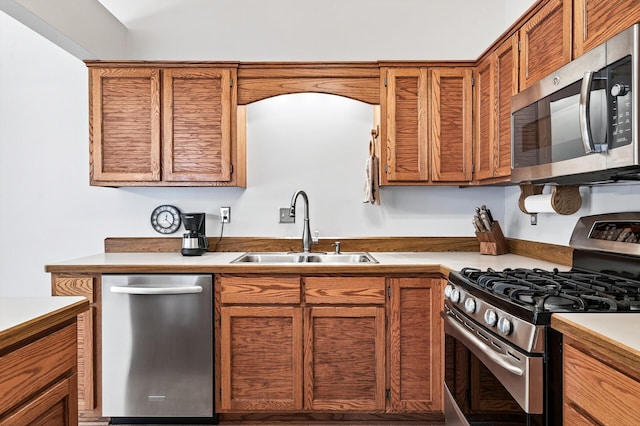 5711 Donegal Dr, Shoreview, MN 55126 - kitchen with stainless steel appliances, brown cabinetry, and light countertops