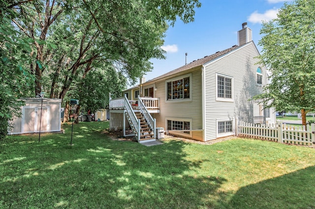 5711 Donegal Dr, Shoreview, MN 55126 - back of property featuring a storage shed, stairway, a chimney, and a deck