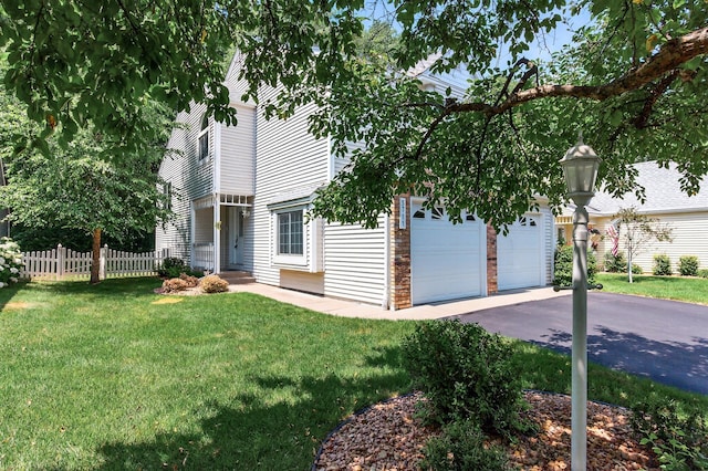 5711 Donegal Dr, Shoreview, MN 55126 - view of property hidden behind natural elements featuring asphalt driveway and a garage