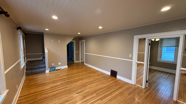 707 11th Ave SE, Rochester, MN 55904 - spare room with light wood-style flooring, stairs, baseboards, recessed lighting, and wooden ceiling