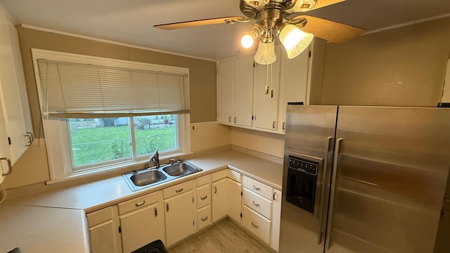 707 11th Ave SE, Rochester, MN 55904 - kitchen with stainless steel fridge, a sink, light countertops, a ceiling fan, and white cabinets