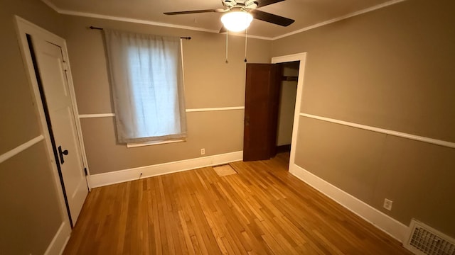 707 11th Ave SE, Rochester, MN 55904 - unfurnished bedroom featuring wood finished floors, baseboards, a closet, ornamental molding, and a ceiling fan